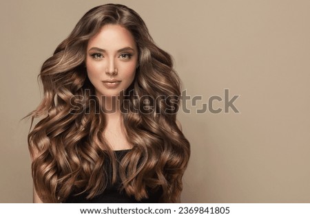 Beautiful laughing brunette model  girl  with long curly  hair . Smiling  woman hairstyle wavy curls .     Fashion , beauty and makeup portrait Royalty-Free Stock Photo #2369841805
