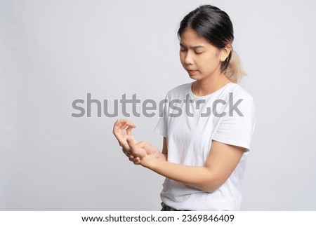 Young beautiful Asian woman suffering from pain in her palm She was massaging her painful hand.