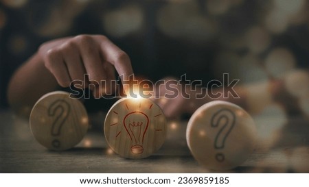 Women touching light bulbs on wood. The process of problem-solving or idea formation. Question mark and light bulb icons. idea concepts.