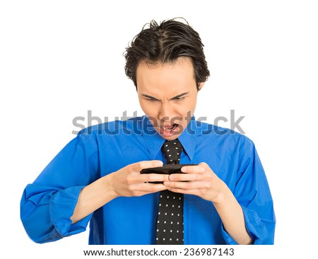 Closeup portrait young business man shocked surprised guy with opened mouth by what he sees on his cell phone isolated white background. Negative human emotion facial expression feeling perception