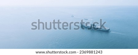 Amphibious Assault Ship. Navy aircraft carrier Aerial top view of battleship, Military sea transport, Military Navy Rescue Helicopter on board the battleship deck Royalty-Free Stock Photo #2369881243