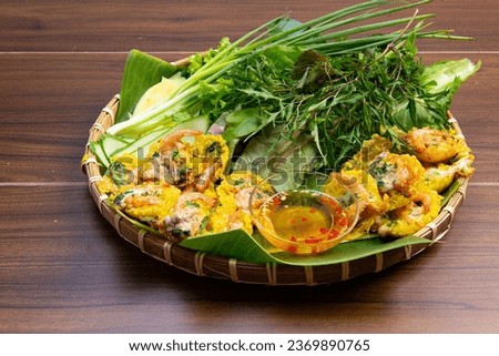 Vietnamese mini pancake is a savory pancake made from rice flour, shrimp, pork, and bean sprouts. It is fried in a small, round mold and served with a sweet and sour dipping sauce.