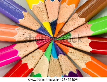 bunch of sharped colored pencils arranged in circle shape on white paper