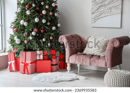 Interior of festive living room with gift boxes under Christmas tree