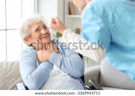Senior woman scared of angry nurse at home Royalty-Free Stock Photo #2369943711