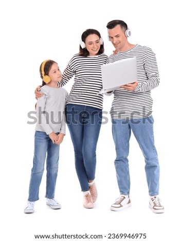 Happy family using laptop and headphones on white background