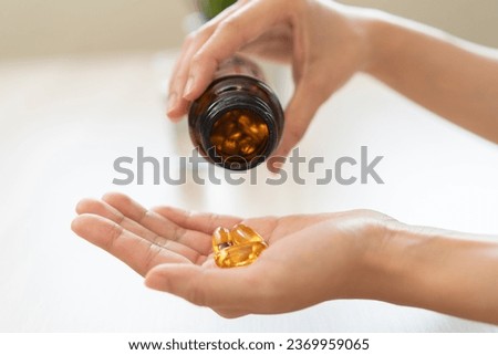Cultivating Wellness: A Person Embraces the Benefits of Fish Oil Supplements for Optimal Health and Vitality Royalty-Free Stock Photo #2369959065