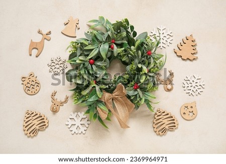 Beautiful mistletoe wreath with Christmas decor on white background
