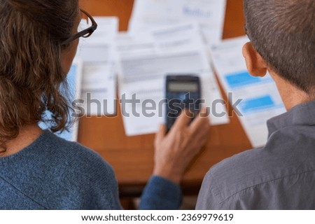 High angle shot Senior business couple managing balance and using calculator with bills and paperwork Royalty-Free Stock Photo #2369979619