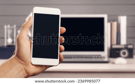 Blank screen phone on laptop background