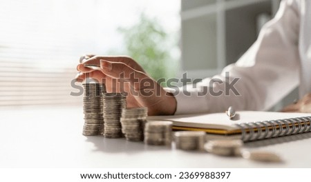 Young Asian woman making stack of coin. invest save finance concept, saving money, investment Royalty-Free Stock Photo #2369988397