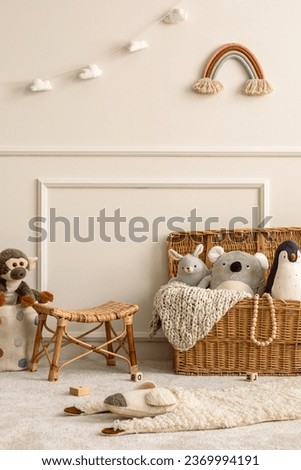 Interior design of kids room interior with wicker basket, plush animal toys, poster, wooden blockers, ladder, white stool, beige wall with stucco and personal accessories. Home decor. Template.