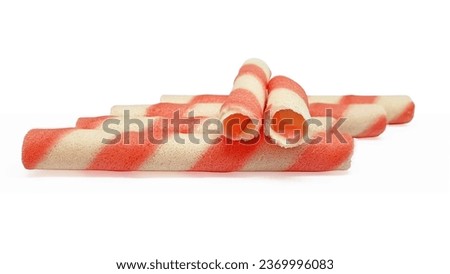 Pink stripe wafer rolls isolated on white background with clipping path and copy space for text. Wafer sticks filled with strawberry cream. Favorite children snacks or ice cream topping.