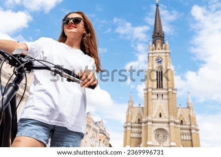 Woman in sunglasses in summer traveling Serbia, Novi Sad city. Bicycle touristic tour.
