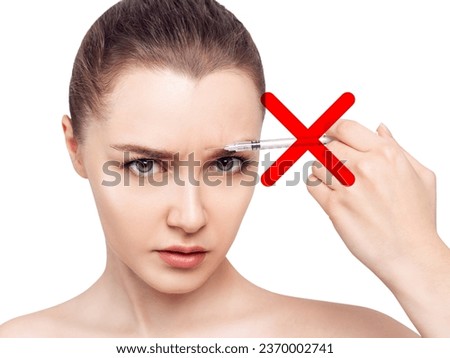 Woman with dissatisfied face with stop sign on syringe.