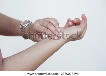 Close up woman hand is checking pulse on wrist hand, compare pulse rhythm with watch. Concept, Medical health care. Self checking heart rate pulse on wrist.    Royalty-Free Stock Photo #2370013299