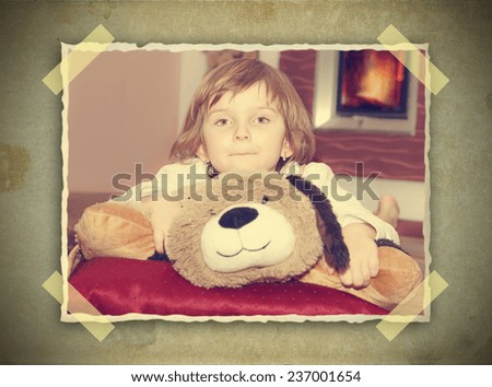 young lying thoughtful girl with teddy bear and fireplace - vintage picture on grunge background with stick papers