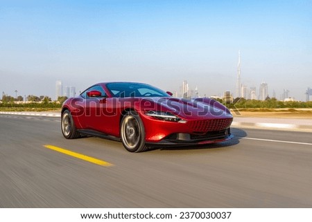 Fast Supercar with a city backdrop Royalty-Free Stock Photo #2370030037