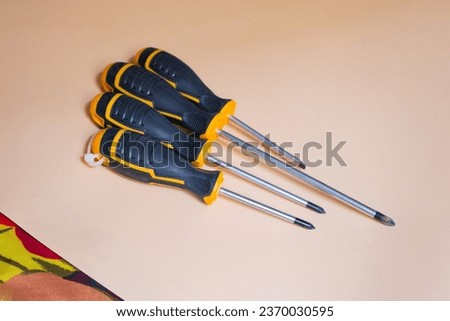 A vibrant and colorful background enhances the visual appeal of a screwdriver, representing the essential tool for DIY and construction projects.