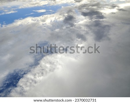 Picture of the sky and clouds taken from a bottom-up angle, but looking like waves of clouds taken from an airplane.