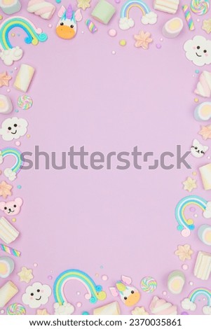 Cute pastel purple kawaii background with frame made of cute air plasticine handmade cartoon animals, unicorns, stars, rainbows. Flat lay, top view, copy space. Beautiful childlike design template Royalty-Free Stock Photo #2370035861