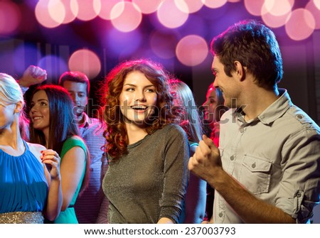 party, holidays, celebration, nightlife and people concept - smiling friends dancing in club Royalty-Free Stock Photo #237003793