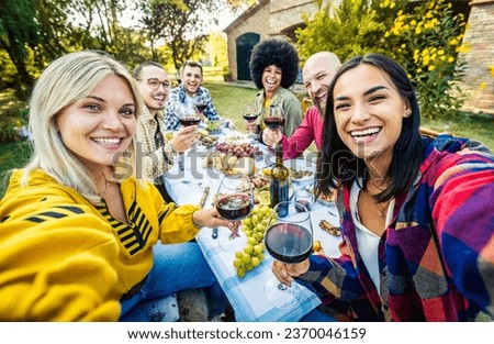 Happy friends having bbq dinner party in garden restaurant - Group of young people taking selfie picture sitting at dining table - Life style concept with guys and girls enjoying picnic together