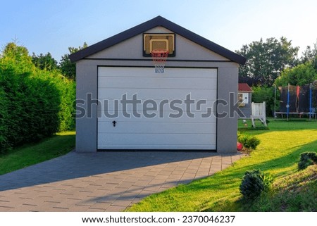 Detached garage in a green garden at summer