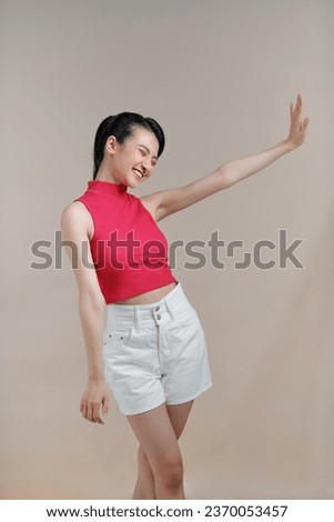 Image of joyful asian woman posing and laughing at camera 