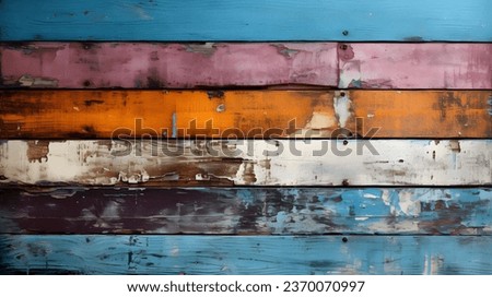 Texture of wood boards with cracked aging paint. Background with wooden planks of different colors. Distressed weathered painted wood. Yellow, blue, pink, and white. Horizontal aspect ratio 16:9. Royalty-Free Stock Photo #2370070997