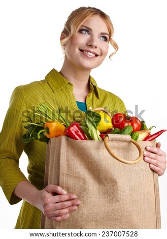 Young woman with a grocery shopping bag. Isolated on white background. 