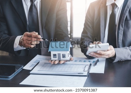 Finance and investment concept, Businessman present business finance investment plan with his partner, Investor colleagues discussing new investment plan by financial graph data on office table