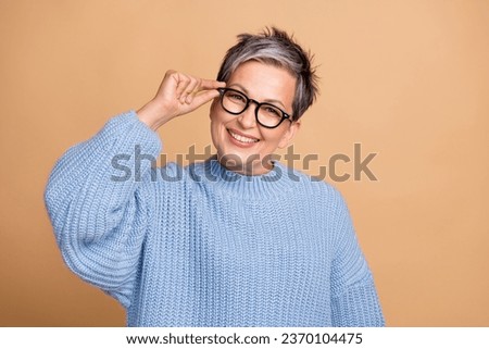Portrait of cheerful successful aged person beaming smile arm touch glasses isolated on beige color background