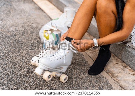 Middle aged woman putting on her roller skates