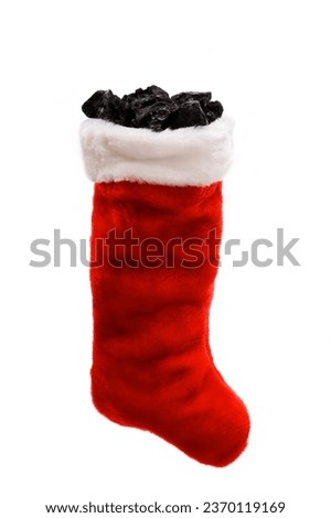 A hanging Christmas Stocking with Coal against a white background