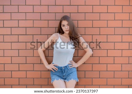 Portrait of beautiful asian chic girl wear black dress pose for take a picture on brick wall,Lifestyle of teen thailand people,Modern woman happy concept