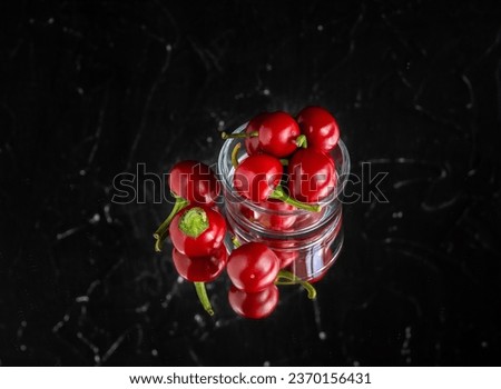 hot cherry pepper, spicy organic paprika	reflection in the mirror on a black background