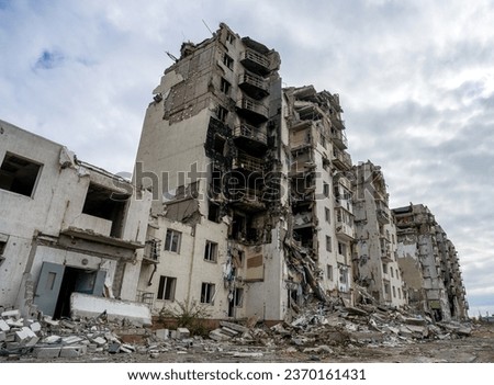 destroyed and burned houses in the city Russia Ukraine war Royalty-Free Stock Photo #2370161431