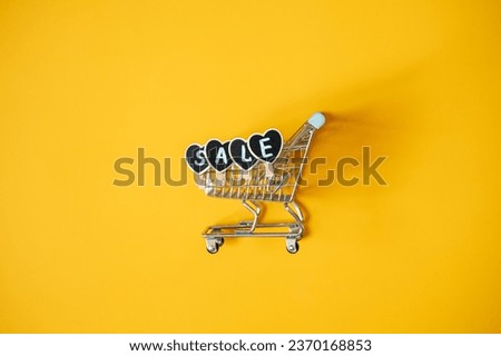 Black Friday Sale concept with shopping cart and heart shape sign SALE. Black Friday sign, Banner, poster on yellow background