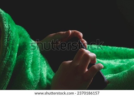 Phone in hands of child. Little boy playing mobile games on smartphone. Hand closeup.