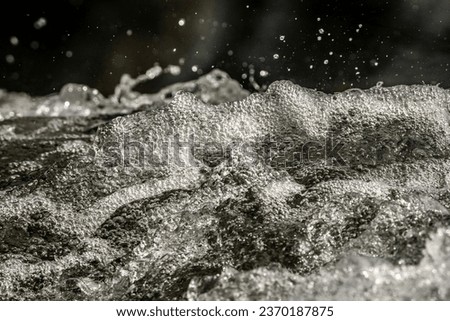 Waterfall close up with water splash and foam in a natural environment fast moving liquid kristal clear Royalty-Free Stock Photo #2370187875