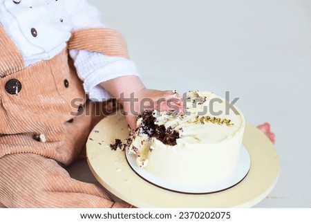 Little child's hands holding a birthday cake