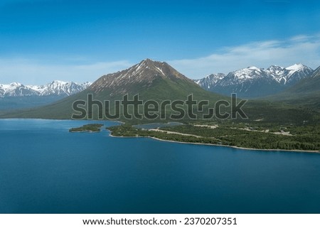 Aerial view of Port Alsworth, Alaska within Lake Clark National Park and Preserve. Private Port Alsworth Airport, public Wilder Natwick Airport, Tanalian Mountain, Chig­mit Mountains, Hardenburg bay. Royalty-Free Stock Photo #2370207351