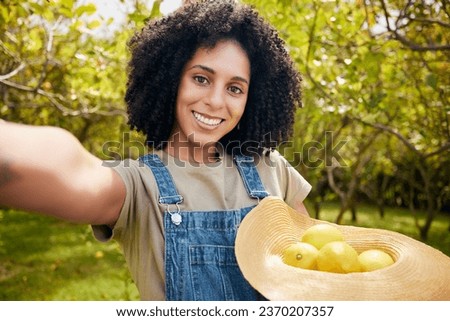 Woman in orchard, selfie and agriculture with lemon in portrait, healthy food and nutrition on citrus farm outdoor. Farmer, picking fruit and smile in picture, harvest organic product and memory