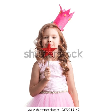 Little fairy girl in Halloween pink dress and crown with magic wand putting spell, isolated on white background
