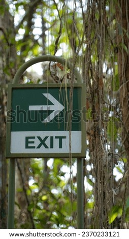 Photo sign exit with green color and eye-catching shape for outdoor area in a city park.