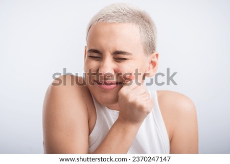 Pretty young woman with a short blond haircut on a white background.