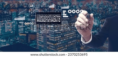 Micropayments theme with businessman in a city at night Royalty-Free Stock Photo #2370253695
