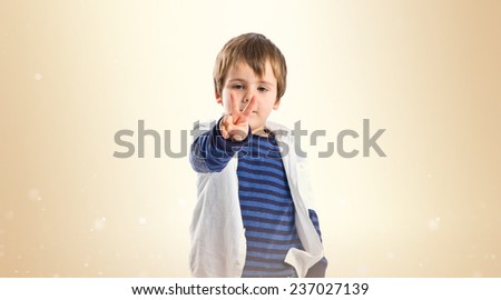 Boys making a victory sign over ocher background 