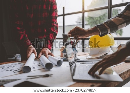 Architects and engineers work together in business, submitting blueprints. architecture plan Construction projects, home design projects, to coordinate further in the function of showing teamwork.